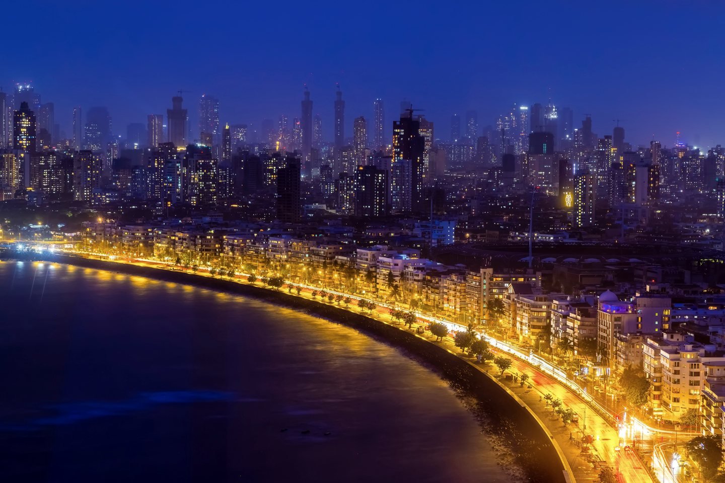 Marine Drive in Mumbai lit up at night along the curve of the bay